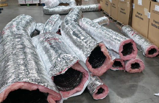 Insulated flexible HVAC ductwork prepared by Tempo Mechanical for residential new construction air distribution installation.